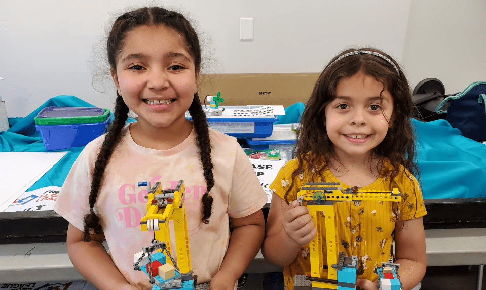 two girls with LEGO projects