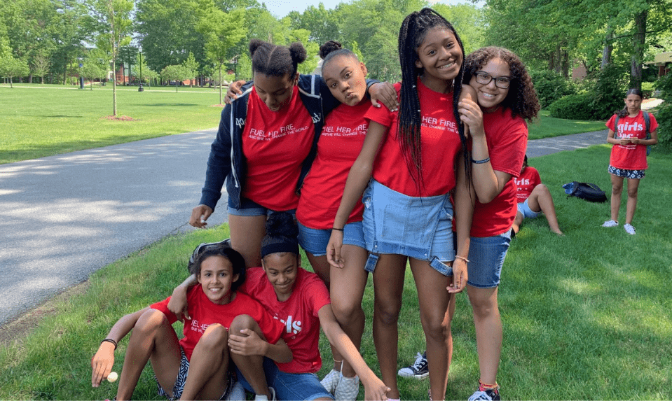 group of girls in red shirts at a park